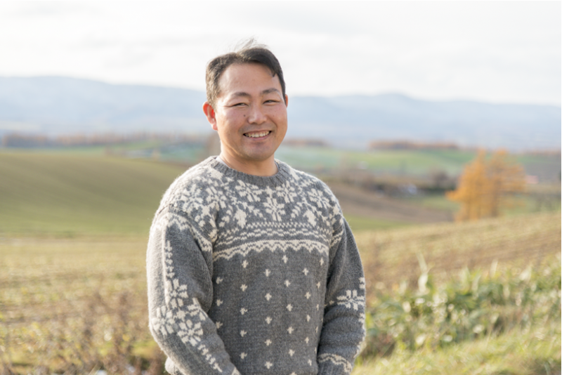 In front of his home is the Biei wheat field, a characteristic view of Hokkaido. Photo: KAWAMURA Isao