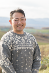 In front of his home is the Biei wheat field, a characteristic view of Hokkaido. Photo: KAWAMURA Isao
